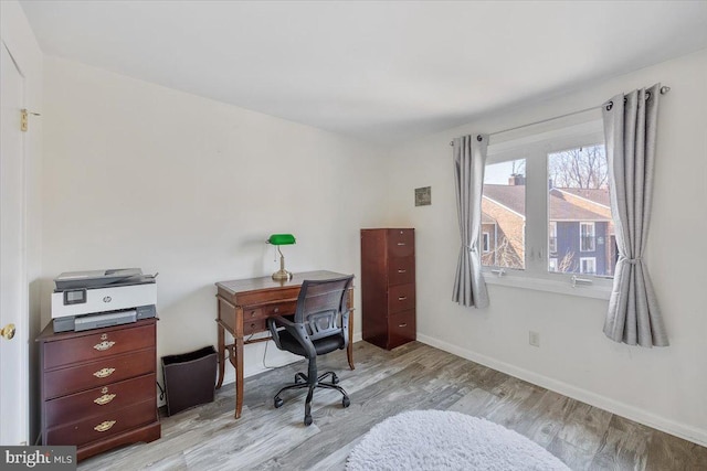 office area with light wood-style flooring and baseboards