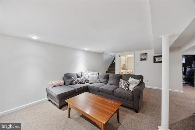 living room featuring stairway, baseboards, and carpet