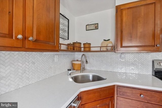 kitchen featuring a sink, brown cabinets, tasteful backsplash, and light countertops