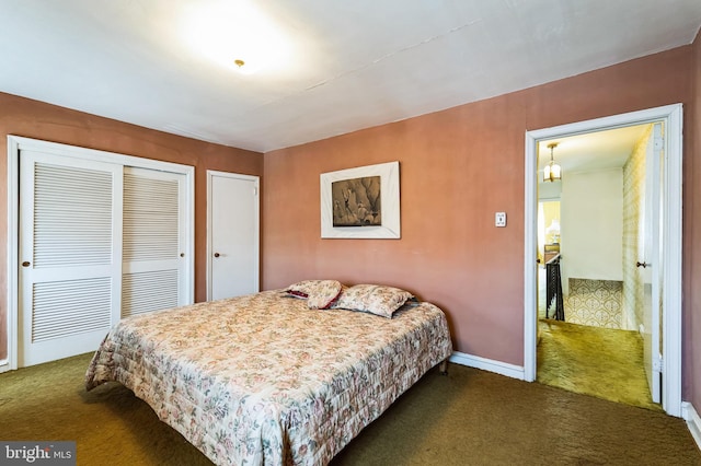 bedroom featuring a closet, baseboards, and dark colored carpet