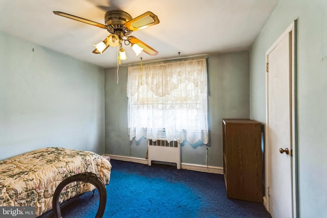 carpeted bedroom featuring radiator, baseboards, and a ceiling fan