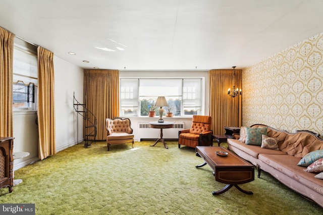 living room featuring baseboards, wallpapered walls, radiator heating unit, and carpet