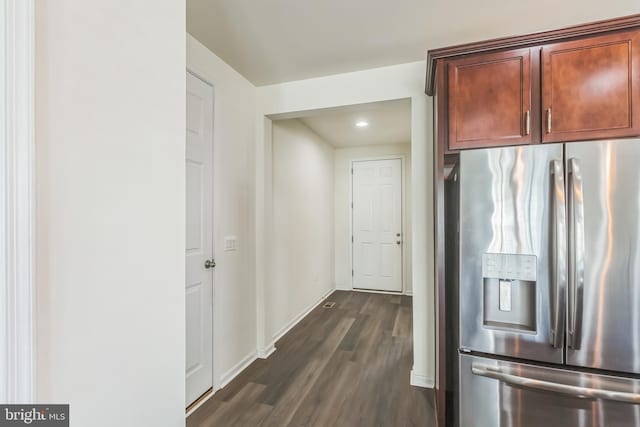 kitchen featuring dark wood finished floors, baseboards, and stainless steel refrigerator with ice dispenser