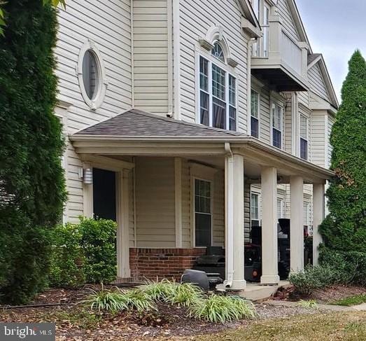 entrance to property with roof with shingles