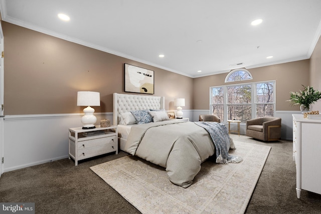 carpeted bedroom with visible vents, recessed lighting, a wainscoted wall, and ornamental molding