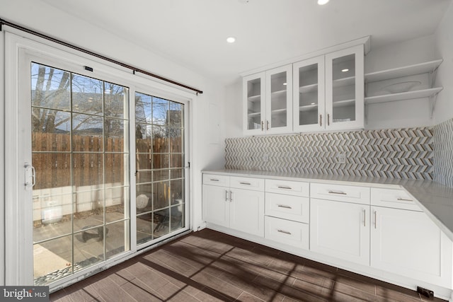 interior space with open shelves, glass insert cabinets, light countertops, and white cabinetry