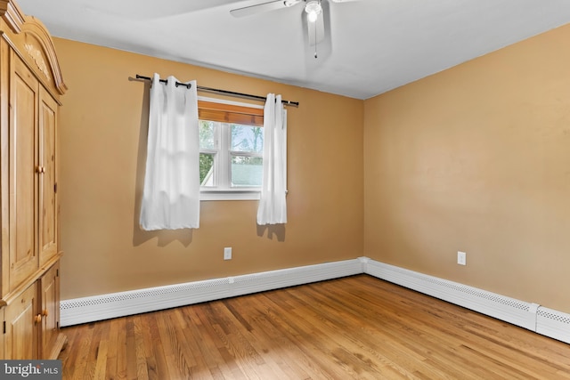 unfurnished room featuring baseboards, light wood-type flooring, baseboard heating, and ceiling fan