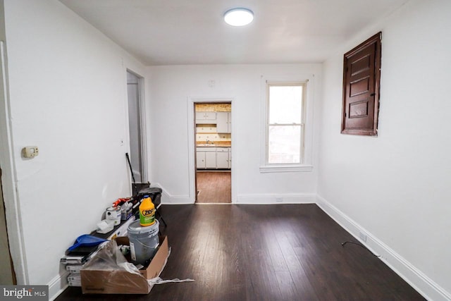 interior space featuring baseboards and wood finished floors