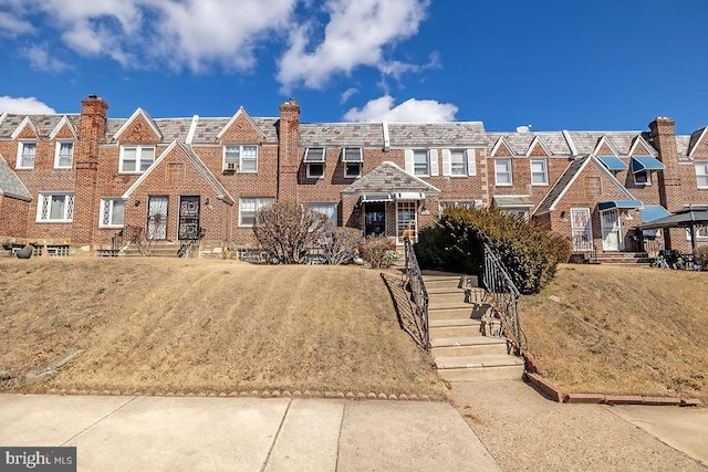 townhome / multi-family property featuring brick siding and a residential view