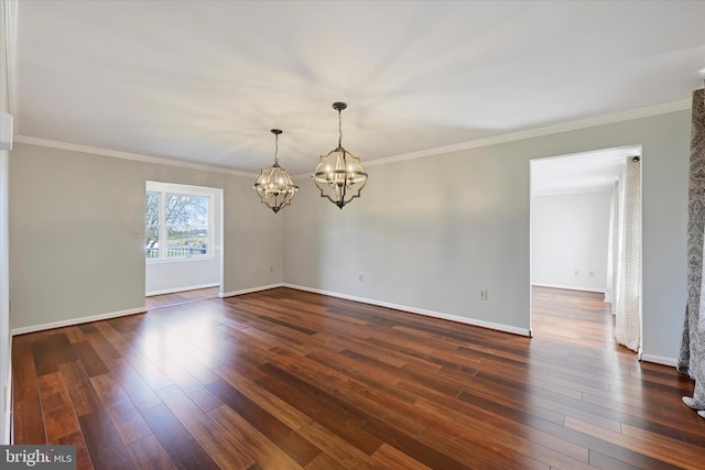 empty room with dark wood finished floors, crown molding, baseboards, and an inviting chandelier