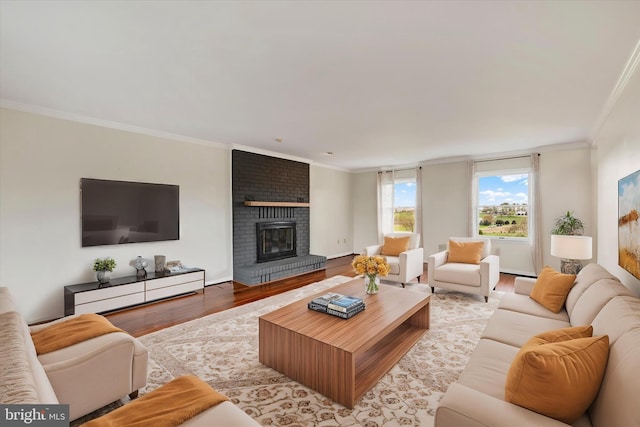 living area featuring a brick fireplace, wood finished floors, and ornamental molding