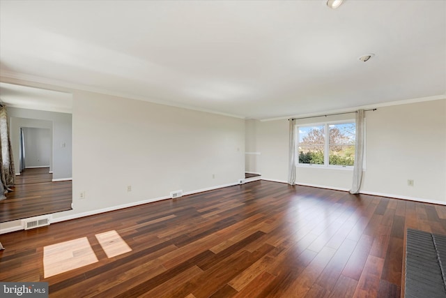 unfurnished room featuring baseboards, visible vents, dark wood finished floors, and crown molding