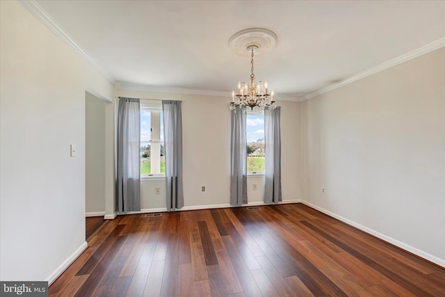 empty room featuring hardwood / wood-style flooring, baseboards, a notable chandelier, and crown molding