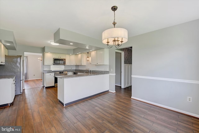 kitchen with a notable chandelier, baseboards, and appliances with stainless steel finishes