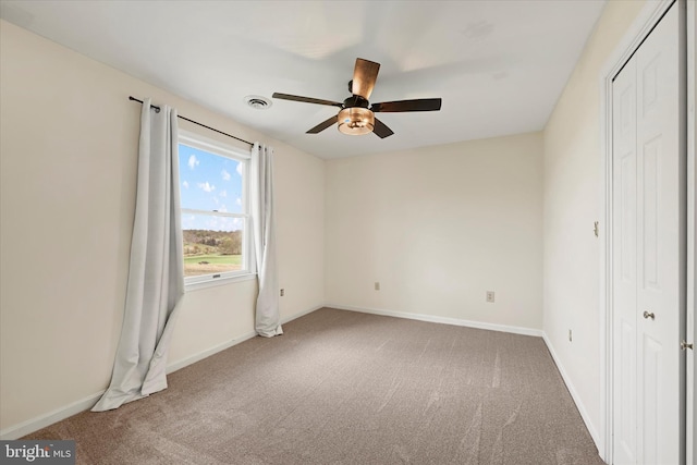 unfurnished bedroom featuring baseboards, a ceiling fan, visible vents, and carpet