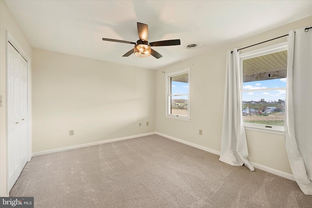unfurnished bedroom with a closet, visible vents, carpet flooring, and baseboards