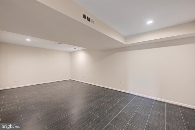 finished below grade area with baseboards, visible vents, and recessed lighting