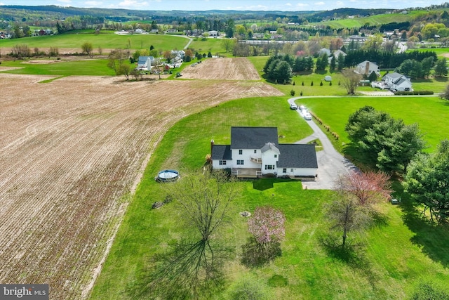 birds eye view of property with a rural view