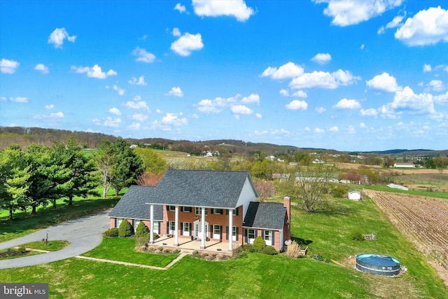 birds eye view of property featuring a rural view