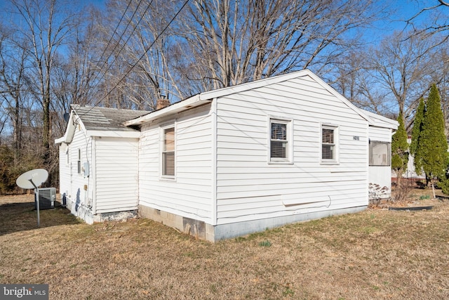 view of side of property with a lawn and crawl space