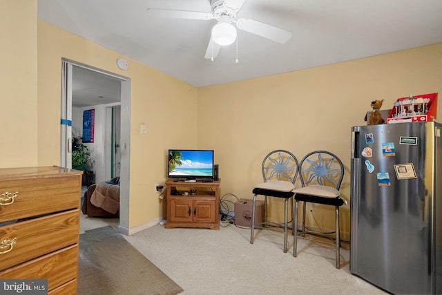 interior space with baseboards, carpet floors, and ceiling fan