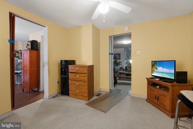 bedroom with baseboards, light carpet, and ceiling fan