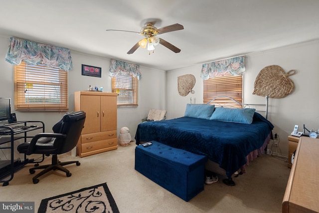 bedroom featuring multiple windows, carpet, and a ceiling fan