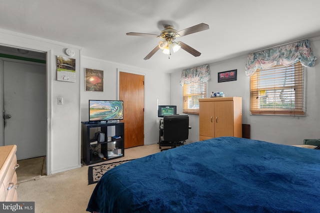 bedroom featuring a ceiling fan and light colored carpet