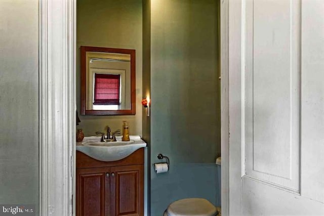 bathroom featuring toilet and vanity