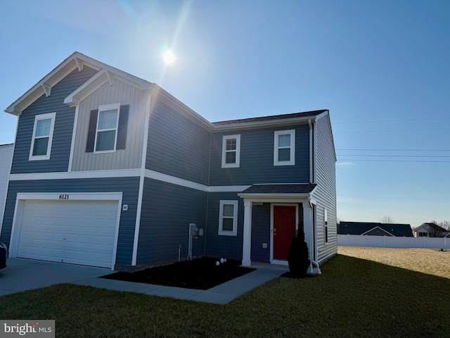 view of front of property with a front yard, an attached garage, and fence