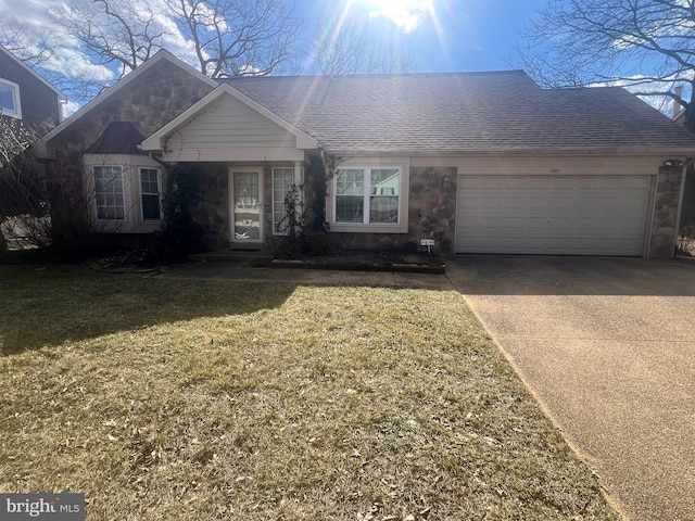 ranch-style house with driveway, stone siding, a shingled roof, a front yard, and an attached garage