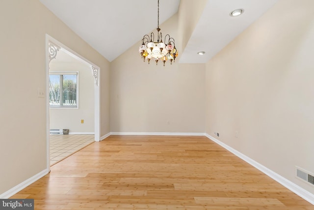 empty room with visible vents, baseboards, light wood-type flooring, lofted ceiling, and a notable chandelier