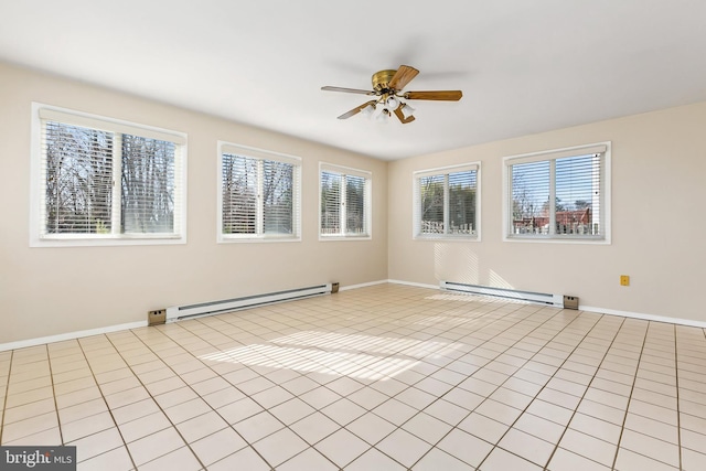 spare room with light tile patterned floors, a baseboard heating unit, baseboards, and a ceiling fan