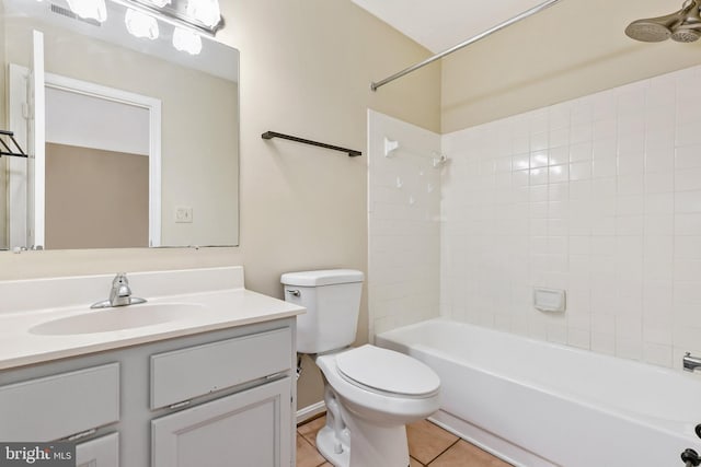 bathroom with washtub / shower combination, toilet, vanity, and tile patterned flooring