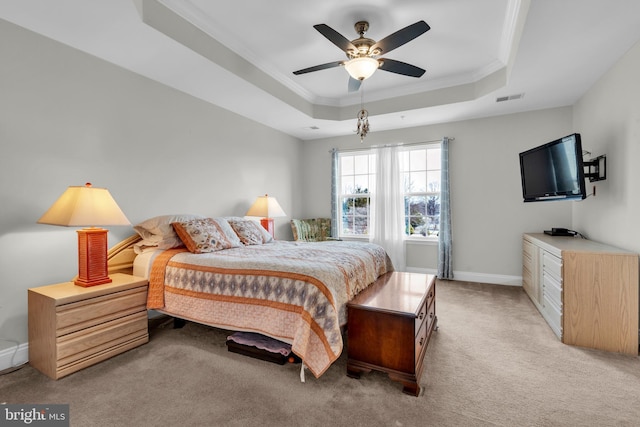 bedroom featuring visible vents, crown molding, baseboards, light carpet, and a raised ceiling