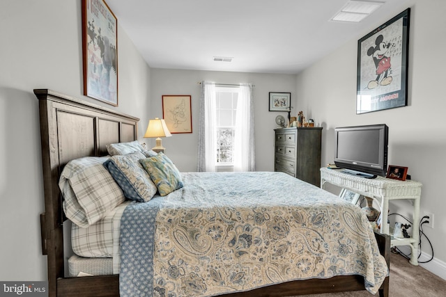 carpeted bedroom featuring visible vents