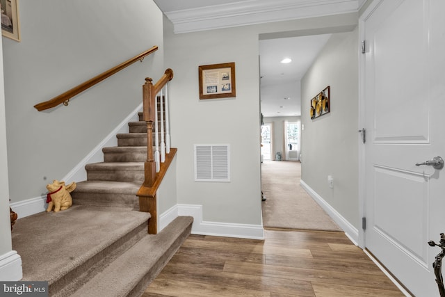 stairs with visible vents, ornamental molding, wood finished floors, recessed lighting, and baseboards