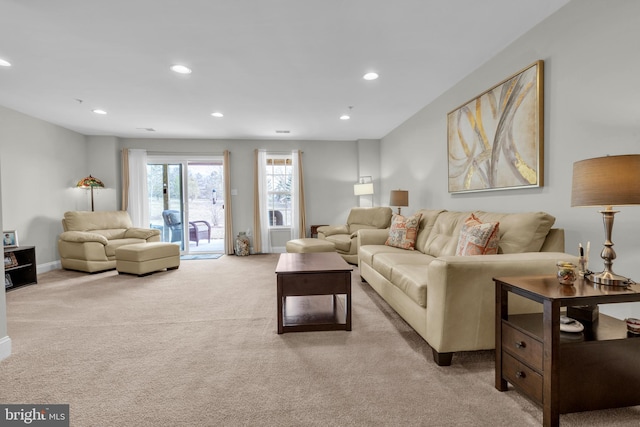 living room featuring recessed lighting, baseboards, and light colored carpet