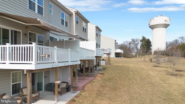 view of yard with a deck, a patio, and a residential view