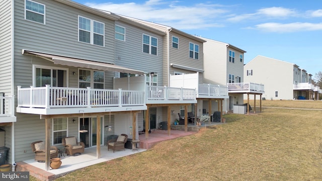 rear view of property with a residential view, a lawn, and a patio area