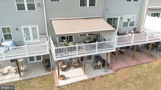 rear view of property featuring a patio area and a deck