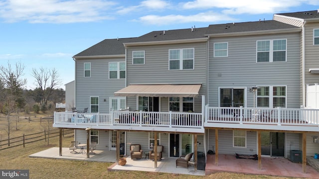 back of house with fence, a deck, and a patio area