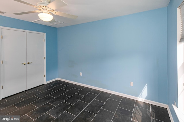 unfurnished bedroom with a ceiling fan, baseboards, visible vents, and a closet