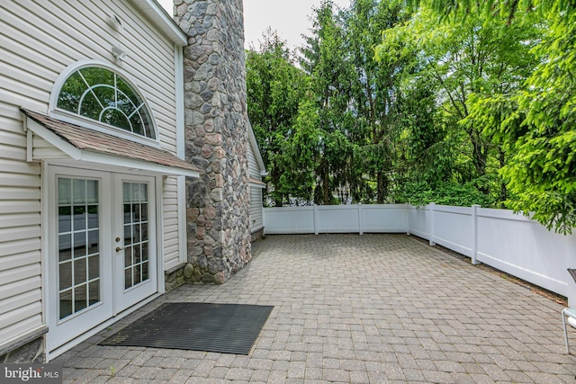 view of patio with french doors and fence