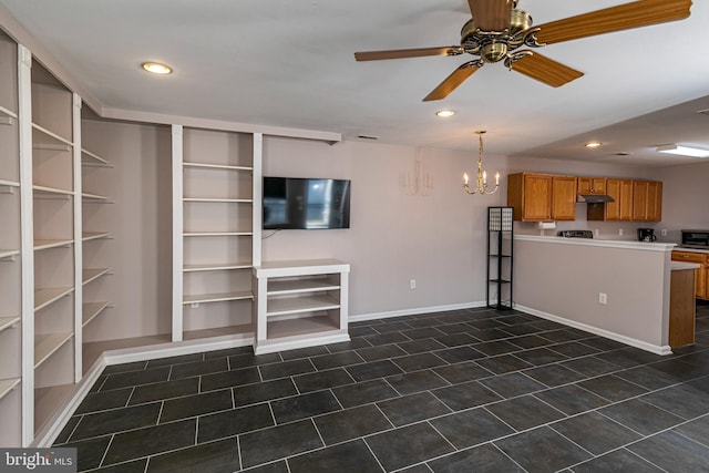 interior space with dark tile patterned floors, recessed lighting, ceiling fan with notable chandelier, and baseboards