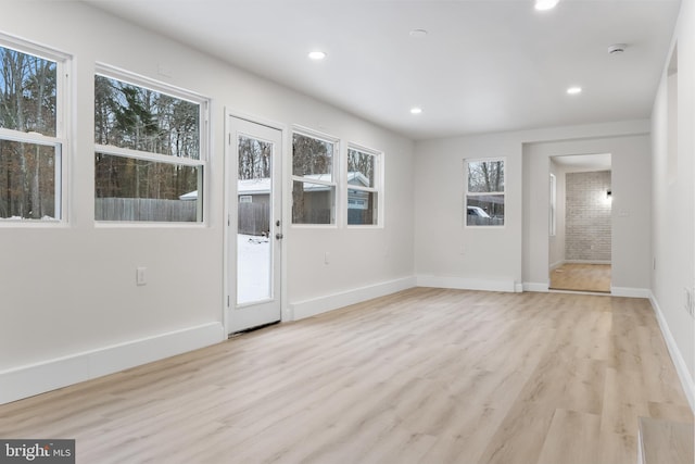 spare room with light wood-style flooring, baseboards, and recessed lighting