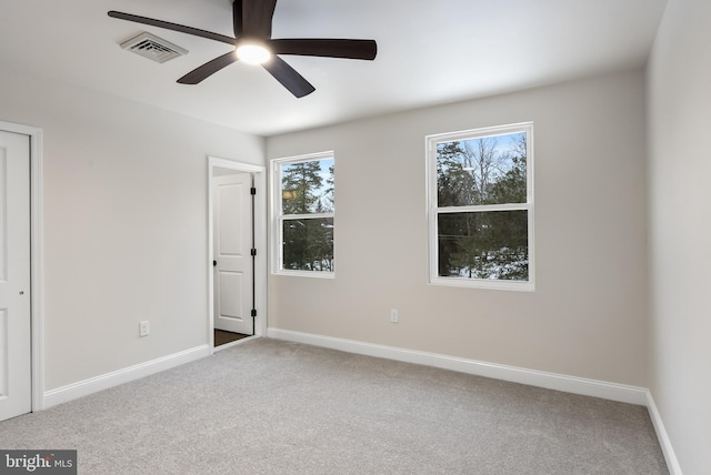 unfurnished bedroom with carpet floors, visible vents, ceiling fan, and baseboards