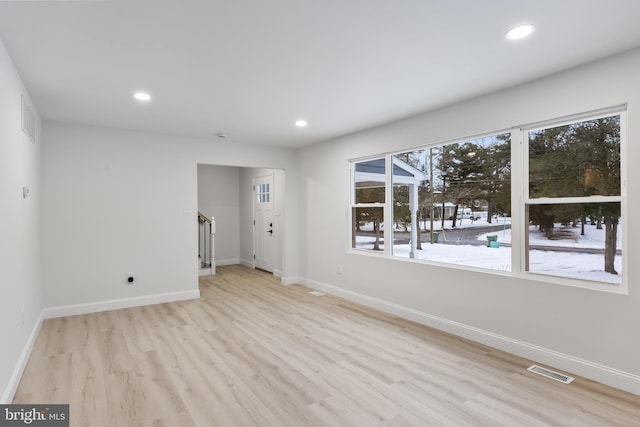 unfurnished room with light wood-style floors, recessed lighting, visible vents, and baseboards