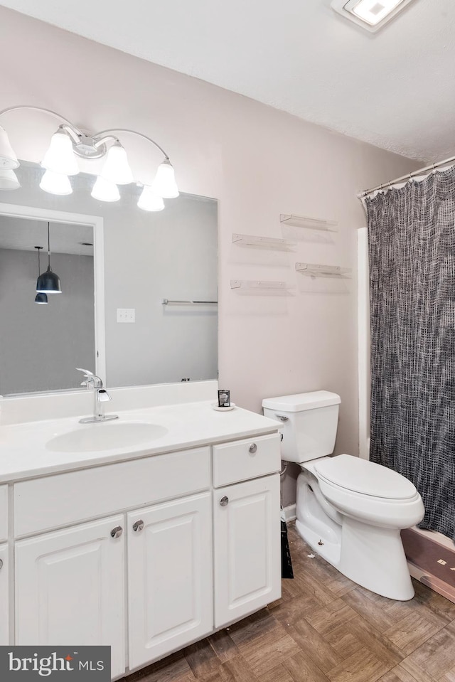 full bathroom with vanity, a shower with shower curtain, and toilet