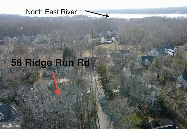 aerial view featuring a wooded view